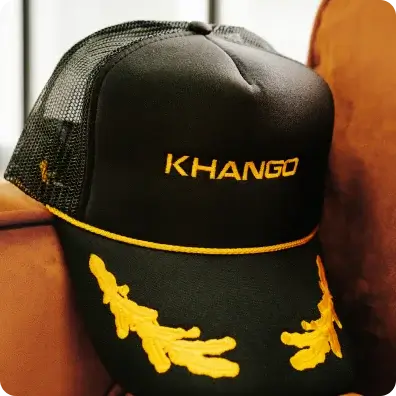 Custom Cap Black trucker hat with KHANGO embroidery.