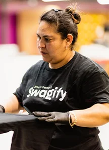Woman preparing promotional apparel.