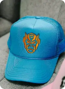 Blue cap with orange embroidery.