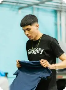 Person holding a custom navy shirt.
